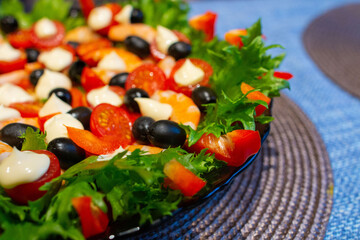 shrimp, olive, and seafood salad in close-up. space for text.