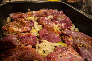 turkey meat sprinkled with spices before baking in the oven. close-up.
