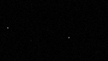 Black background with white specks and two bright spots snow falling snow