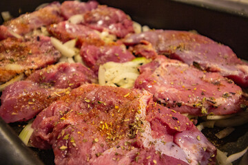 turkey meat sprinkled with spices before baking in the oven. close-up.