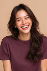 Fototapeta premium Portrait of a Happy Asian Woman Laughing with Long Brown Hair, Isolated on Beige Background