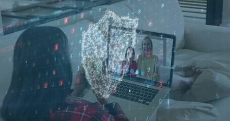 Animation of digital shield and padlock over woman having video call on laptop - Powered by Adobe