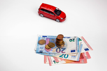 euro cash and toy vehicle isolated on white, money  for car loan payment and insurance concept