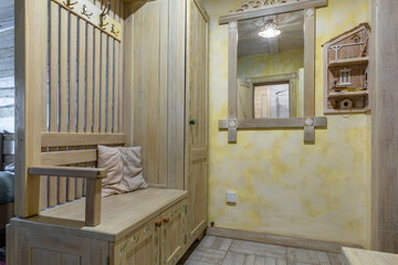 Rustic hallway with yellow walls and painted wooden furniture