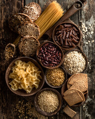 Cooking essentials a colorful array of pasta grains and legumes on rustic wood table still life natural light