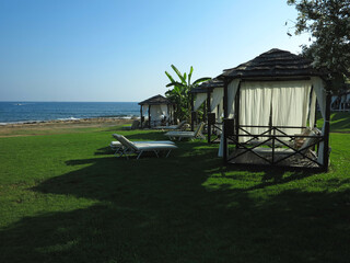 Beautiful landskape, palm trees and sun loungers at luxury resort