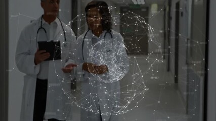Two doctors walking corridor while hologram materializing rotating around tablet for data review - Powered by Adobe