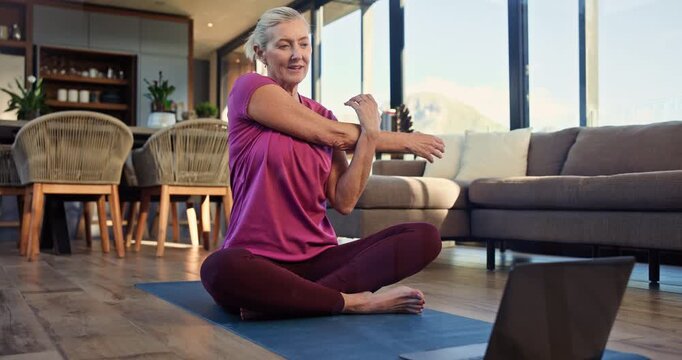 Woman, stretching and laptop on mat, home and exercise routine in living room, warm up and wellness. Healthy, mature person and workout preparation on floor, online and tips for pilates on website