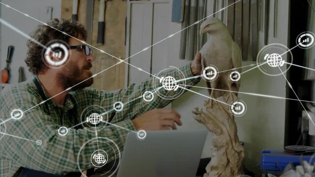 Craftsman rotating bird sculpture while tapping trackpad and initiating data overlay for analytics