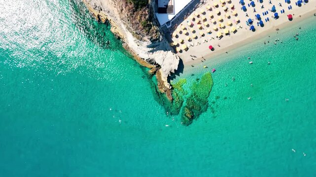 Stunning summer top-down drone shot of Tropea coastline and crystal clear waters