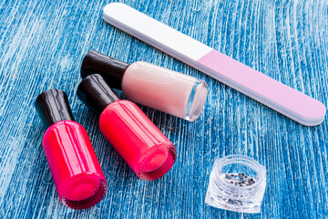 color nail polish with manicure set on blue background
