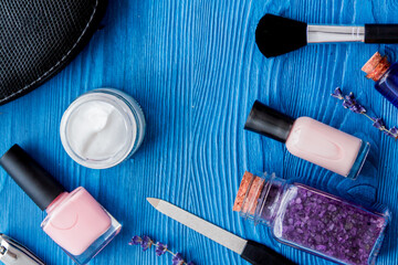 cosmetic and manicure set on wooden background top view