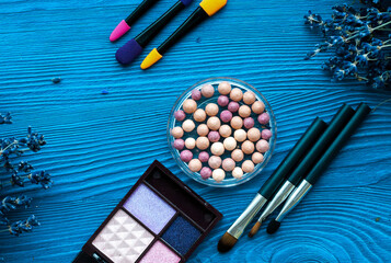 decorative cosmetics with lavender on wooden background top view