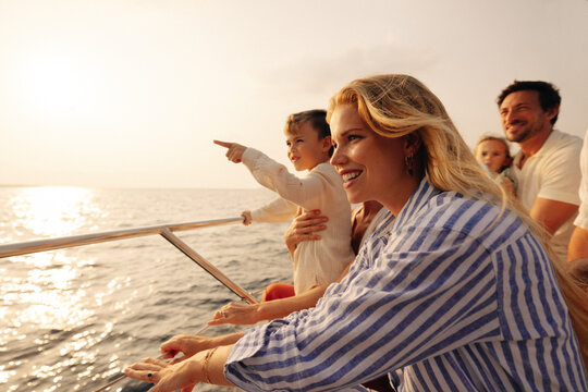 Family shares a special moment on a boat at sunset