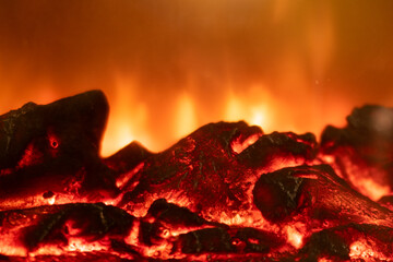 Intense orange flames burning wood