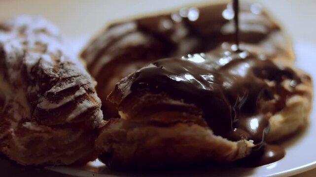 Covering the eclairs with melted chocolate