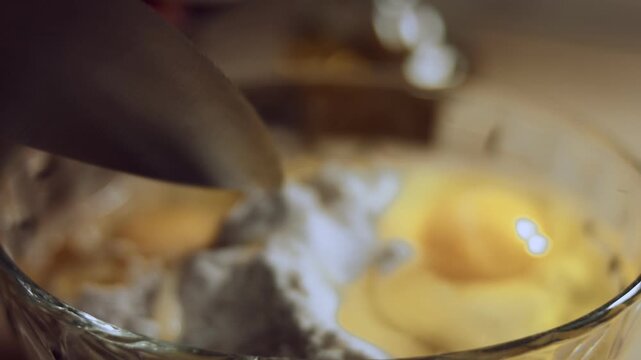 Adding salt to the pile of white flour and eggs in a glass bowl