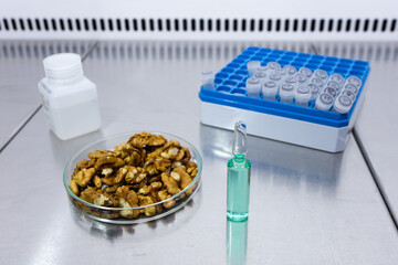 An ampoule containing a transparent medicine obtained in a laboratory from walnuts.