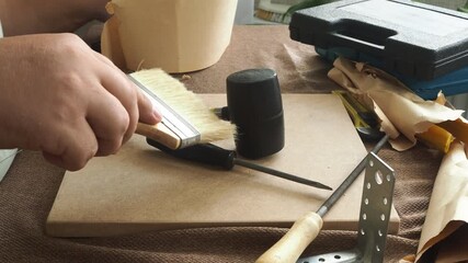 A man checks work tools at his workplace.