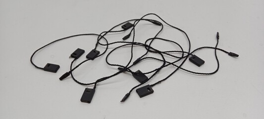Black hangtag thread piled on a white background