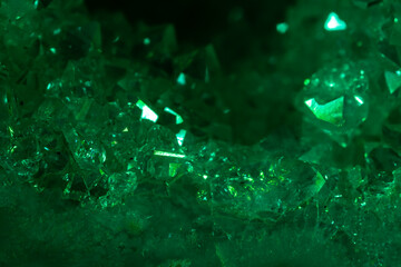 Green crystal mineral stone. Gems. Mineral crystals in the natural environment. Texture of precious and semiprecious stones. Seamless background with copy space colored shiny surface of precious stone