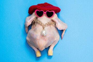 A chicken adorned with heart-shaped sunglasses and a red hat on a bright blue background, showcasing a humorous and playful theme. perfect for quirky concepts and fun design projects.