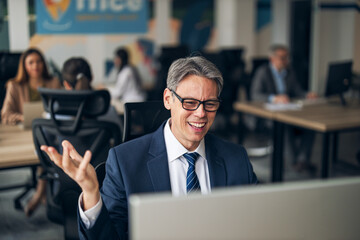 Happy businessman discussing ideas during office collaboration