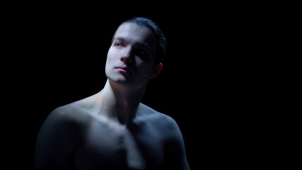 Male portrait with reflective expression in cinematic low light. Concept of emotional awareness campaigns, mental wellbeing visuals, aesthetic clinic communication, and premium brand storytelling.