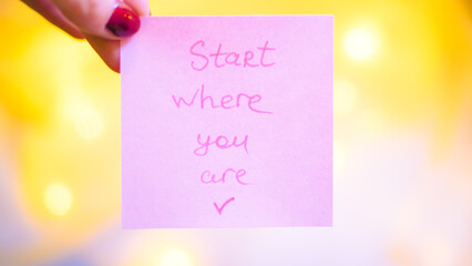 Inspirational note with motivational quote on pink sticky paper