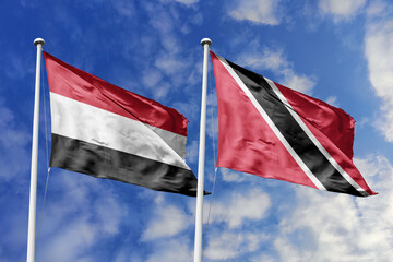 Vivid 3D illustration of the Yemen and Trinidad and Tobago flags waving together, representing international relations, Caribbean ties, and diplomatic cooperation between diverse cultures.