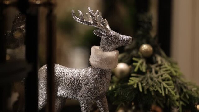 Silver reindeer framed by staircase balusters with warm lighting