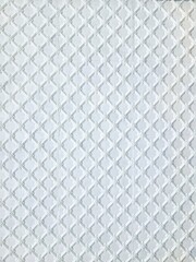 Naklejka premium Elegant white ornamental wall panel with embossed floral lattice pattern.