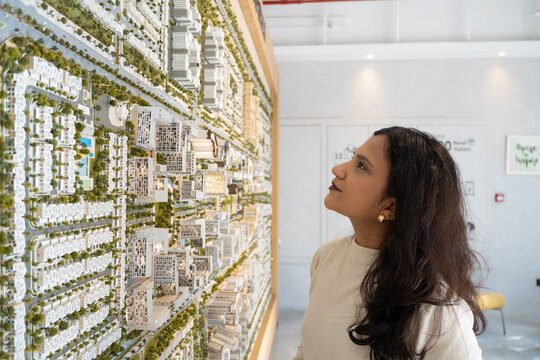 Client reviewing residential layout while selecting home to buy in Dubai, Dubai property investment, residential community master plan model