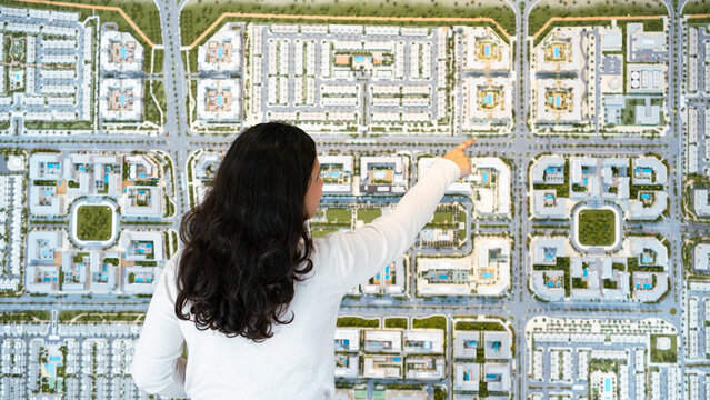 Real estate professional showcasing premium residential community model to first time home buyer in Dubai