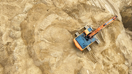 Excavator, soil movement, construction equipment, aerial photography from a drone, industrial excavation, large-scale construction of facilities. High quality photo