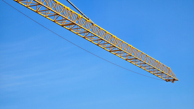 Yellow construction crane, heavy construction machinery, large-size lifting mechanisms, high-rise construction, urban development, industrial mechanics and cargo logistics. High quality photo