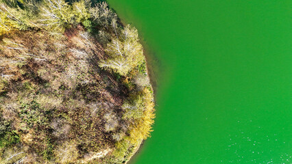Top view of the shore of a green lake, a natural reservoir, a natural habitat, a panoramic shot, an ecological space for recreation and tourism. High quality photo