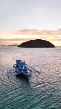 Bird's-eye survey of the blue transport commuting boat in Linapacan Tourists Camp, in New Culaylayan Island, Philippines