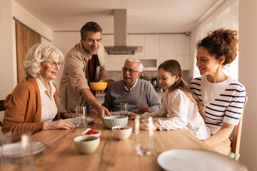 Multigenerational family gathering, enjoying meal time at home
