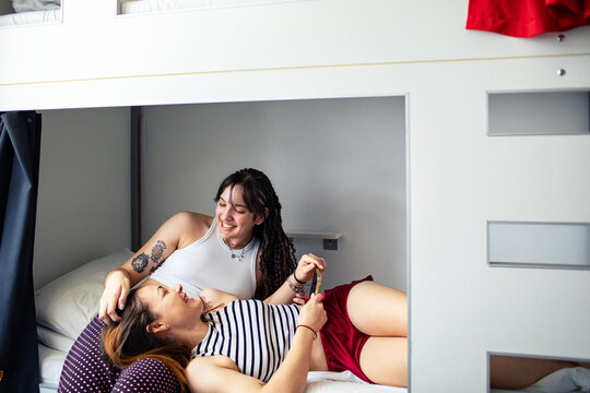 Roommates relaxing in bunk bed
