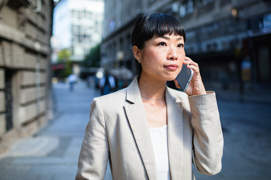 Businesswoman on phone in urban setting