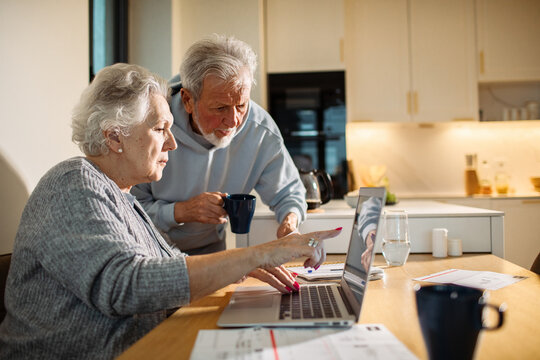 Senior couple reviewing finances at home