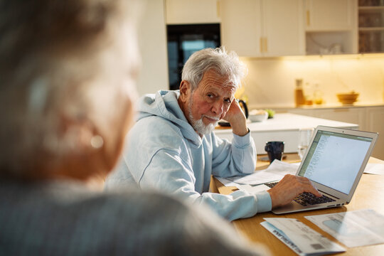 Senior man worried about finances at home