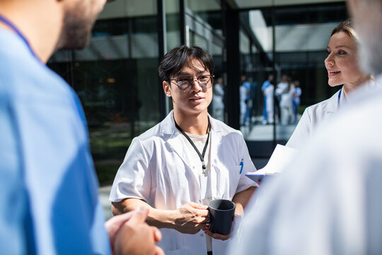 Group of healthcare workers on a break in the hospital courtyard