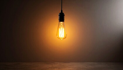 Warm amber glow radiating from a single light bulb suspended in a dimly lit room