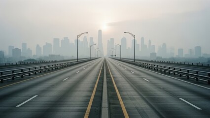 Empty multi-lane highway leading to a modern city skyline under a hazy sky at dawn.