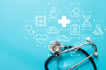 Stethoscope with digital medical icons interface on blue background. Concept of healthcare technology, telemedicine, health insurance, hospital service, diagnosis, and wellness checkup.
