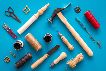 Leather craft or shoemaker tools flat lay. The workplace in a leather workshop