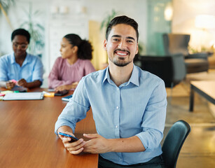 Portrait of a group of young business people having a meeting in the office. Teamwork and success concept, portrait of a smart young businessman or university teacher using a smartphone phone and text