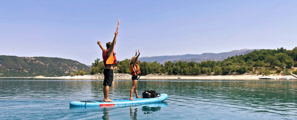 Happy family paddling in summer vacation on the river